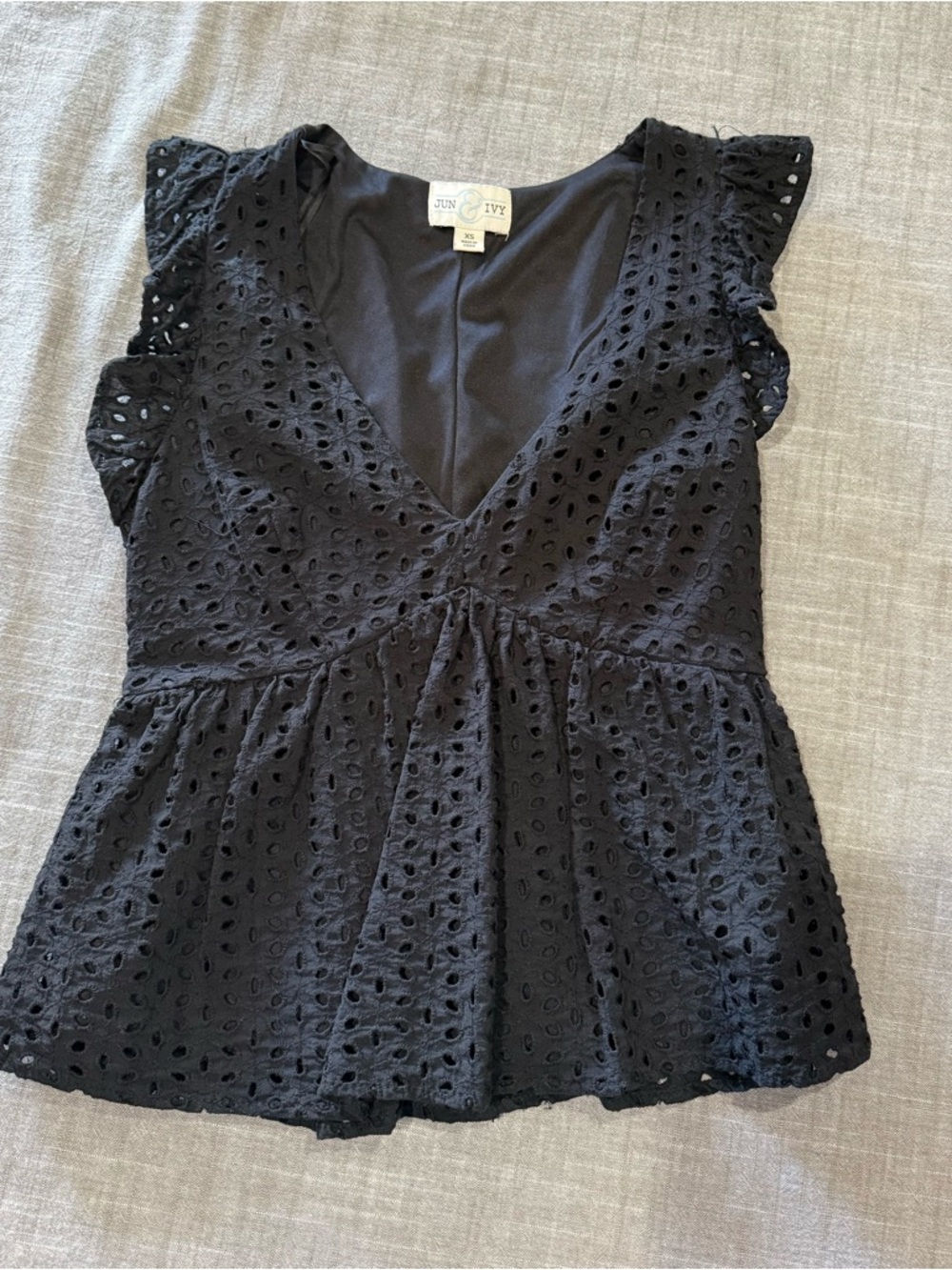 Black Eyelet V-Neck Peplum Blouse by Jun & Ivy